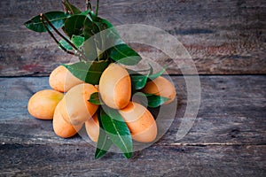 Fresh marian plum on wood background.