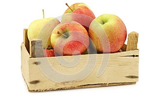 Fresh Maribelle apples in a wooden crate