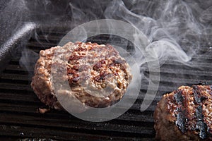 Fresh meat cutlets in a frying pan grill photo