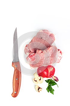 Fresh meat with garlic, tomato, pepper ready to cook with Ingredient, Top view of raw steak on cutting board with spices and knife