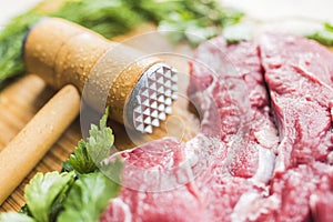 Fresh meat, parsley and a hammer to beat meat