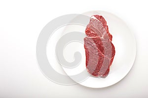 Fresh meat on plate on white background