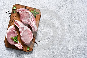 Fresh meat. Ribs on a wooden board with spices on a light background. Pork steak