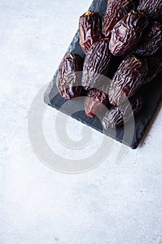 Fresh medjoul dates on a slate board. Top view and copy space