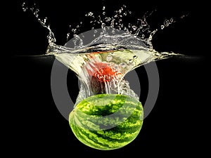 Fresh melon falling in water with splash on black background