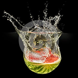 Fresh melon falling in water with splash on black background