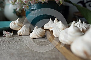 Fresh meringue cookies on linen cloth.