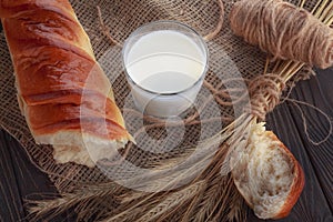 Fresh milk in a glass and baguette