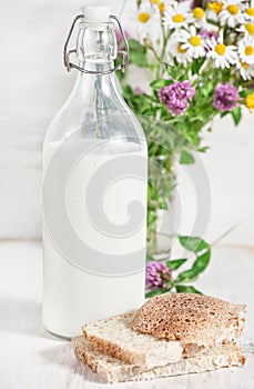 Fresh milk in old fashioned bottle and homemade bread