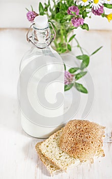 Fresh milk in old fashioned bottle and homemade bread