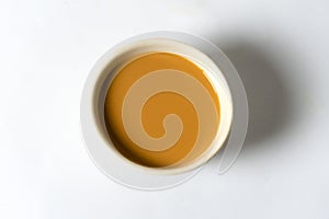 Fresh milk tea or indian karak chai in payali or masala tea in clay cup on white background. top view