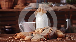 Fresh milk and whole grain flaxseed bread on wooden table in village house, food rotating slowly