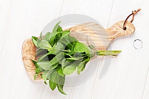 Fresh mint bunch on cutting board