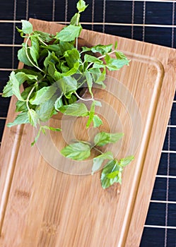 Fresh mint in a wooden brown bowl on the table