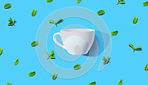 Fresh mints with tea cup overhead view
