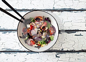 Fresh mix green leaves, tomatoes, soft cheese and walnuts salad