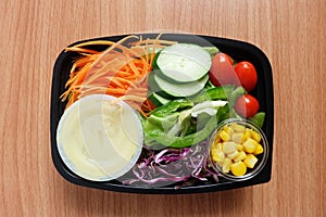 Fresh mix Salad and dressing In clear plastic box. tomato,Carrot sliced,Purple cabbage sliced
