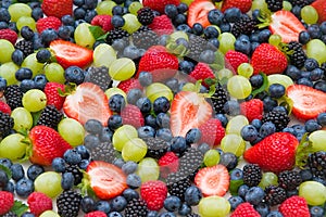 Fresh mixed fruits , strawberries , blueberries background.Healthy food , diet.