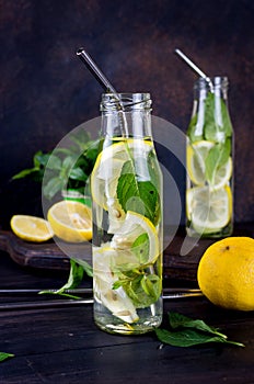 Fresh mojito drinks in bottles and ingredients - lemon and mint photo