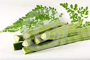 Fresh moringa oleifera fruit and leaves.