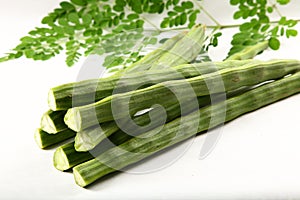 Fresh moringa oleifera fruit and leaves.