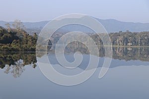 Fresh Morning with misty sky and view of Mountains and forest reflections on the lake water