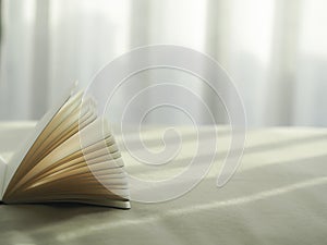 Fresh morning read book on the bed, select focus.