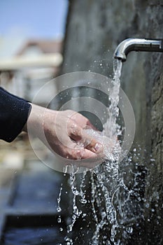 Fresh mountain water falling on hands