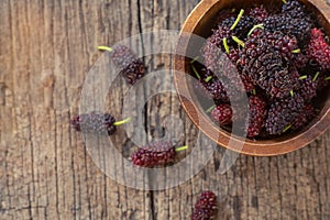 Fresh mulberry fruit on wood table background