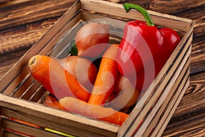 The Fresh multi-colored vegetables in wooden crate