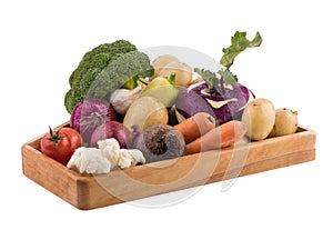 Fresh multi-colored vegetables in wooden crate. Organic food. White background