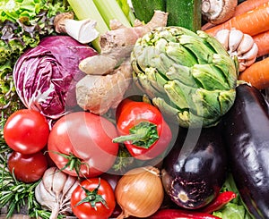 Fresh multi-colored vegetables in wooden crate. Top view.