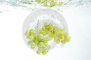 Fresh Muscat white Grapes Falling Into Water, Isolated on White Background