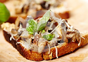 Fresh mushroom bruschettas on a wooden board