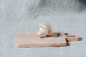 Fresh mushroom champignon on a wooden board. Close-up