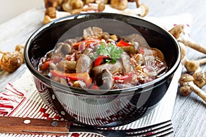 Fresh mushroom stew with red pepper and parsley photo