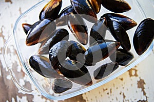 Fresh mussels on an old wooden white table