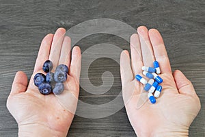 fresh natural fruits vs pills. Natural vitamin in fruits vs synthetic vitamin in pills.