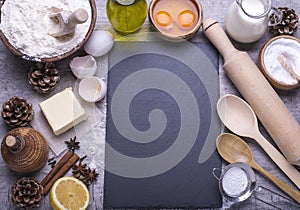 Fresh natural organic ingredients for baking homemade biscuit, cookies on a gray wooden background with board for recipe. Flat lay