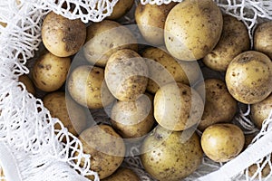 Fresh natural raw potatoes in white bag