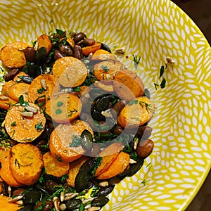 Fresh natural salad with carrot and beans anda pumpkin and sunflower seeds