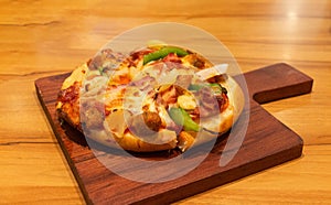Fresh new mini chessy hawaiian pizza on wooden board