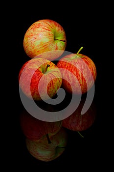 Fresh new zealand red apples with reflections on dark background