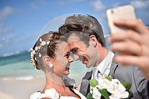 Fresh newly-weds taking selfie