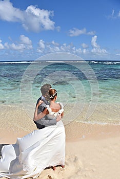 Fresh newly-weds in wedding dresses on caribbean islands