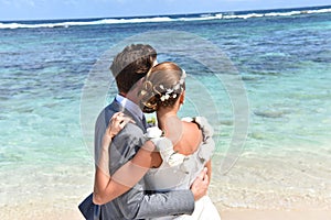 Fresh newly-weds in wedding dresses on caribbean islands