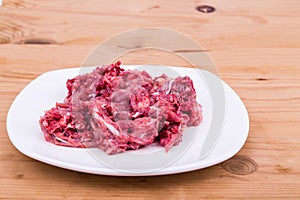 Fresh and nutritious minced raw meat dog food on plate