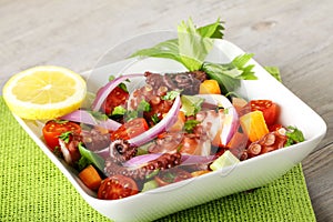 Fresh octopus salad with tomato and onion