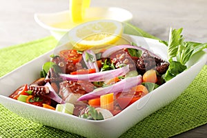 Fresh octopus salad with tomato and onion