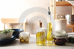 Fresh olive oil and kitchen utensils